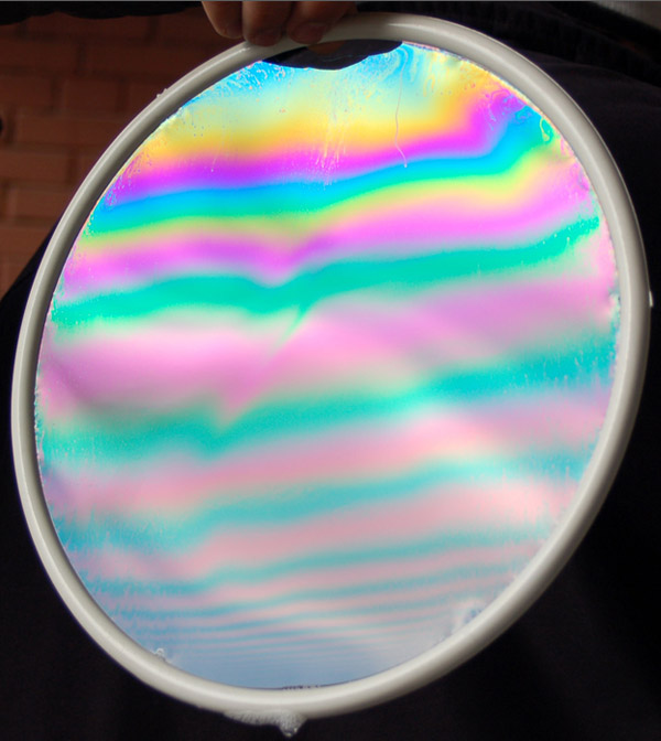 A very thin transparent film of soap solution(thickness → 0 ) is seen under  reflection of whi 